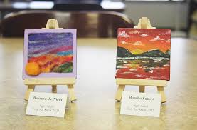 tiny art canvases displayed on easels