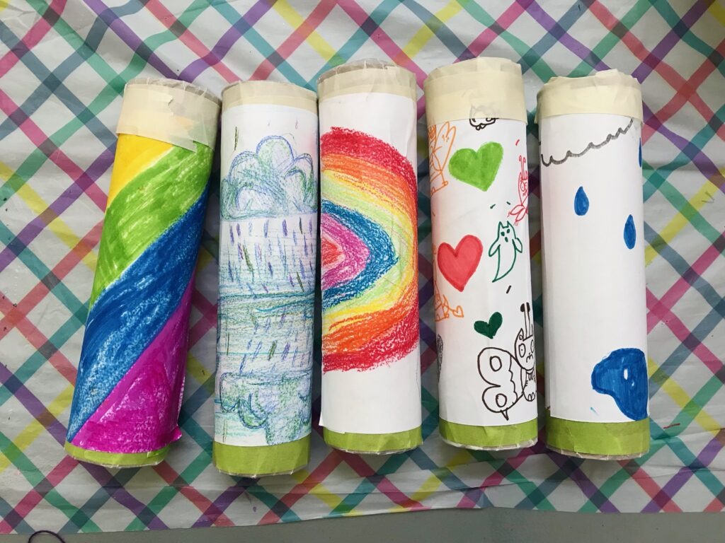 cylinders decorated with paper that has been colored on