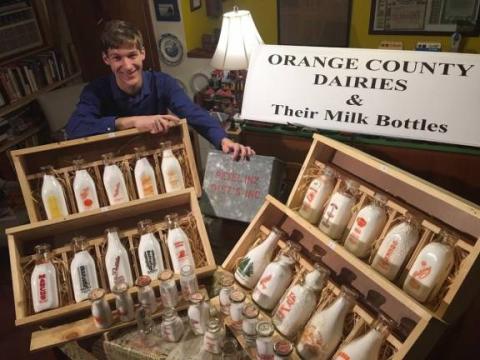 Alex Prizgintas with his collection of milk bottles