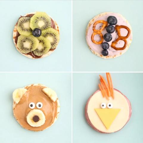 Image of four circular snack clockwise from top left, a kiwi star, a blueberry and pretzel butterfly, a ham and cheese chicken, and a peanut butter and bananna bear.