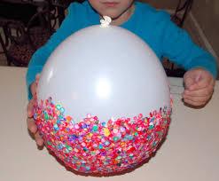 inflated balloon with scraps of paper glued to it to make a bowl