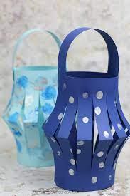 lanterns made of blue construction paper with painted designs