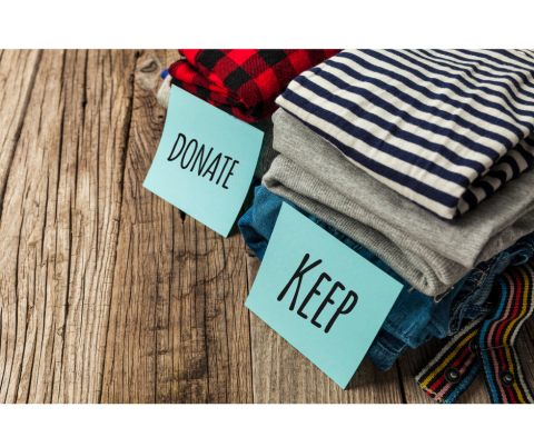 Image: two stacks of folded clothes.  One has a label that reads "donate", the other "keep"