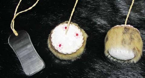 Seal skin balls attached with sinew to a baleen handle