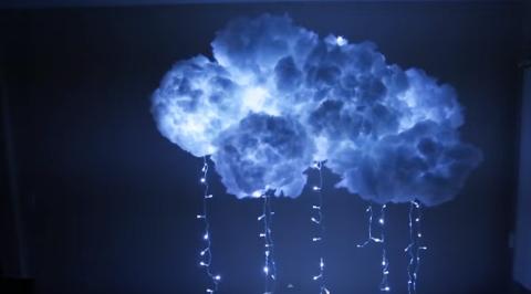 cloud made of batting with LED lights inside and hanging down 