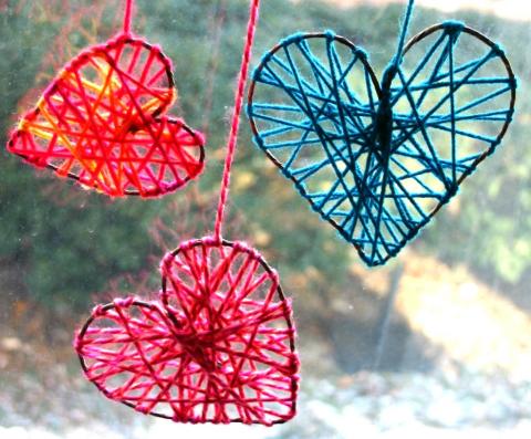 metal hearts with colored yarn strung across them
