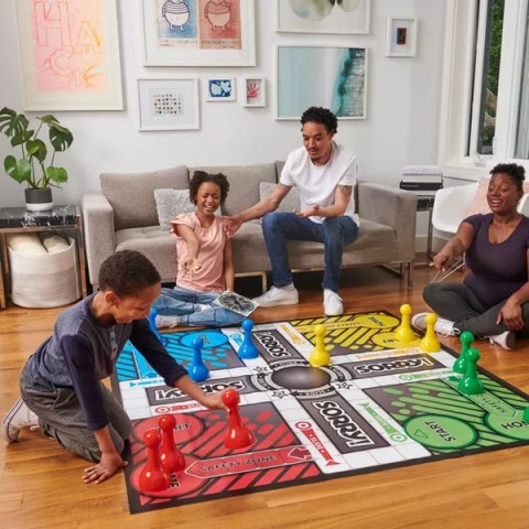 Family playing an oversized game of Sorry!