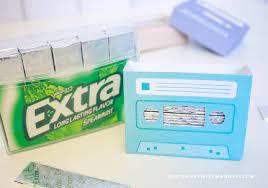 pack of gum next to a gum holder that looks like an audio cassette
