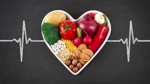 heart healthy foods in a heart with an ekg line