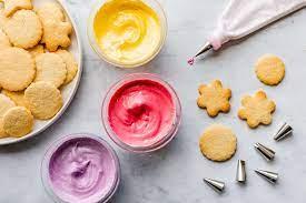 sugar cookies, piping bag, three different colors of icing