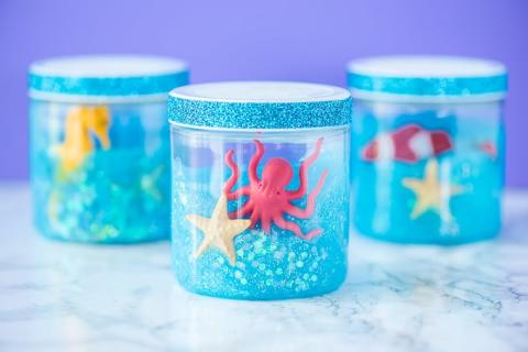 jar with blue slime and plastic sea life