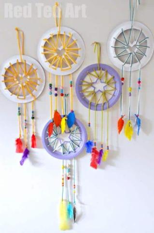 dreamcatchers made of paper plates, yarn, beads, and feathers