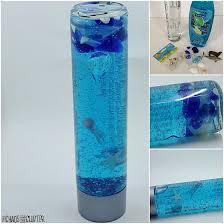 jars with blue water and shark themed toys inside
