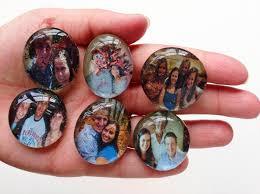 hand holding photos glued to glass beads