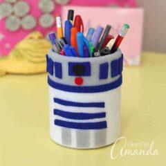 can that looks like R2D2 holding pens and pencils 