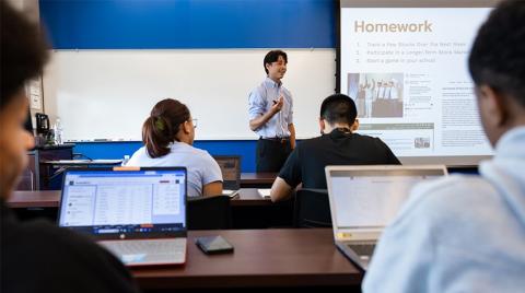 young man teaching group of students