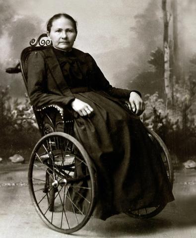 black and white photo of a woman in a wheel chair