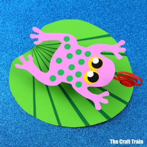 pink paper frog on a green paper leaf