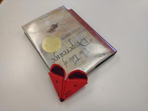 Red corner mouse bookmark on the hardcover book The Tale of Desperaux