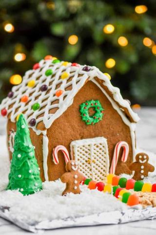 A house made from gingerbread cookie with icing and candies as decorations