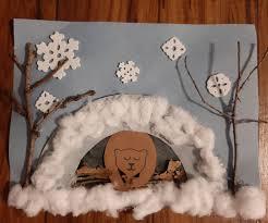 craft of bear hibernating in den with cotton ball snow and trees of twigs