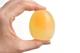 hand holding a rubber egg