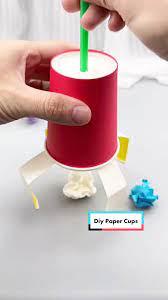 cup with white claws picking up tissue paper balls