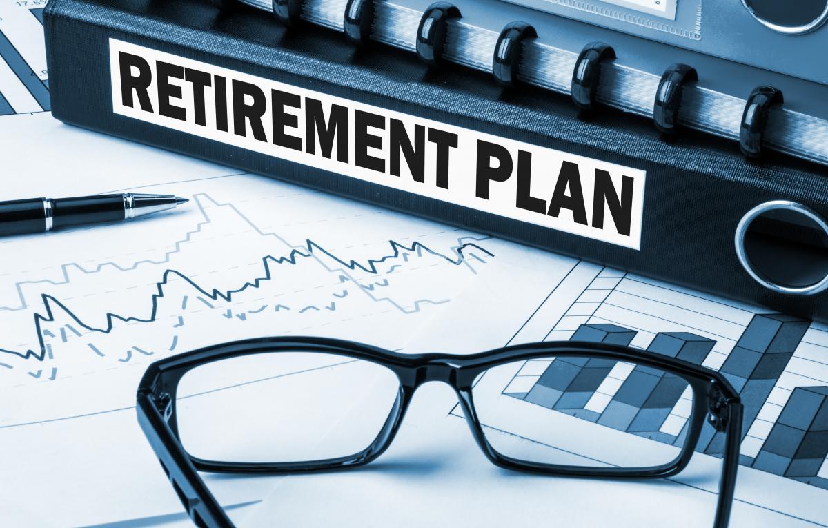 photo of a binder that reads 'retirement plan'