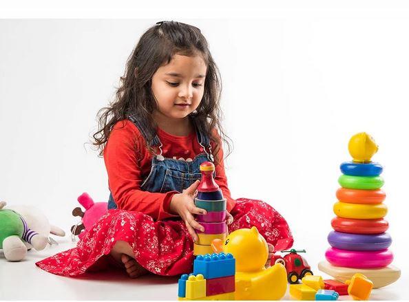 child sitting and playing with blocks