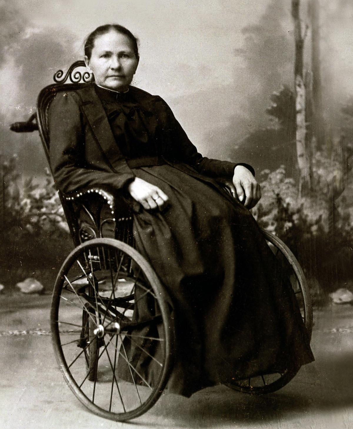 black and white photo of a woman in a wheel chair