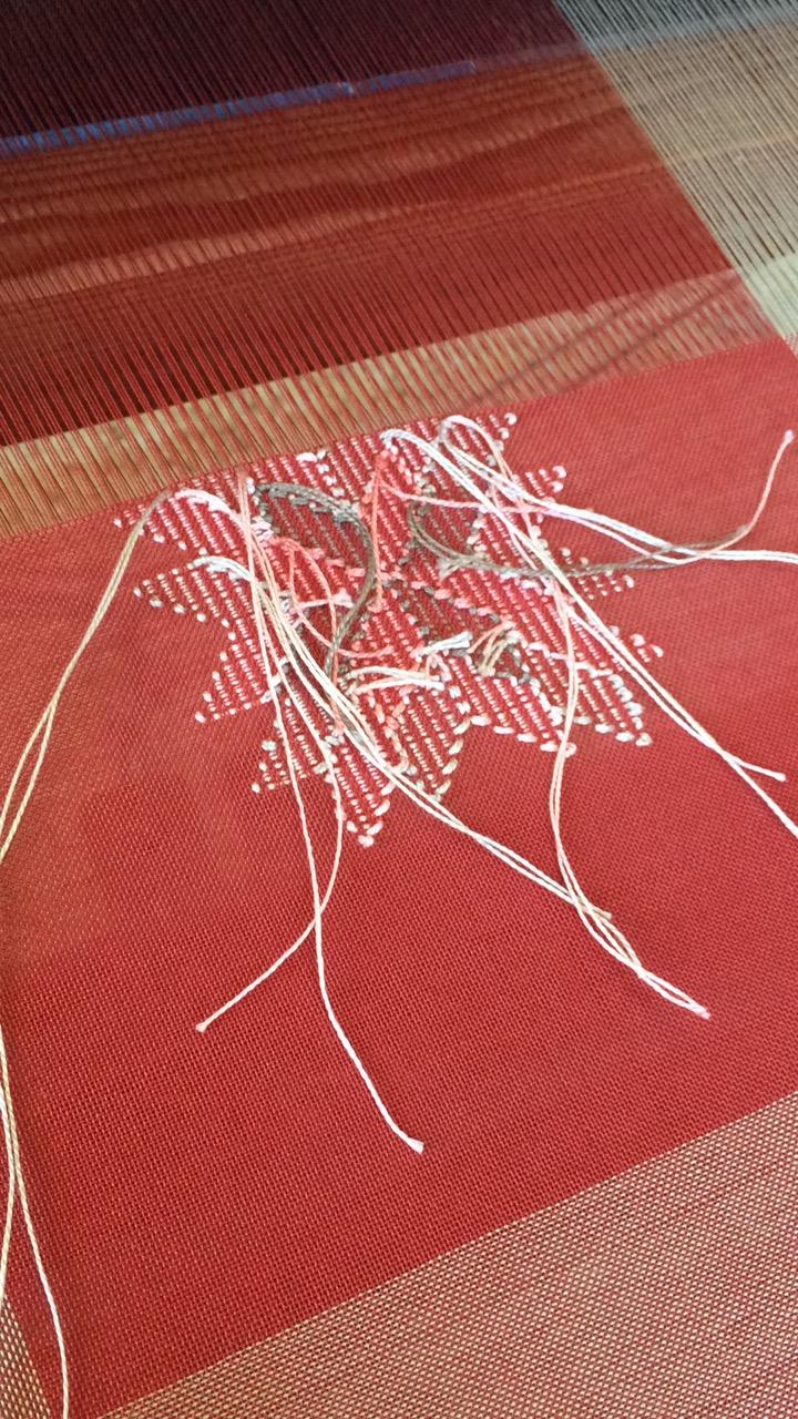 Red weaving with a white star in the center