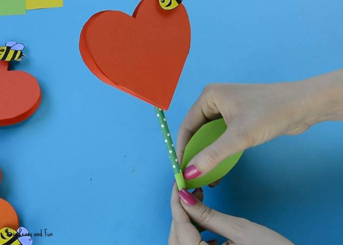 flower made of heart shaped red paper and pencil