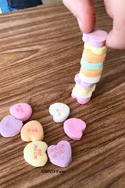 person stacking conversation hearts