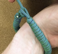 wrist wearing a paracord bracelet