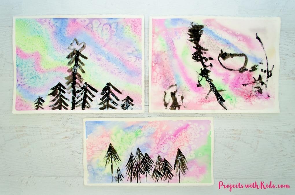 watercolor paintings of the northern lights with black trees