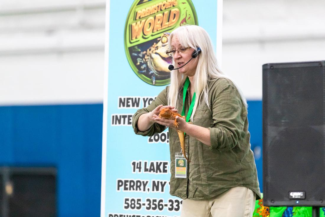 woman holding orange reptile