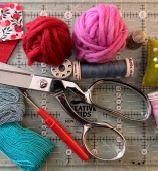 Scissors, crochet needle and thread.
