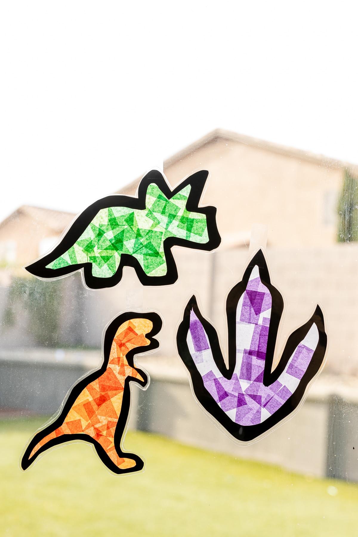 dinosaur shaped suncatchers made with tissue paper