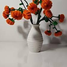 pipe cleaner pumpkins in a white vase