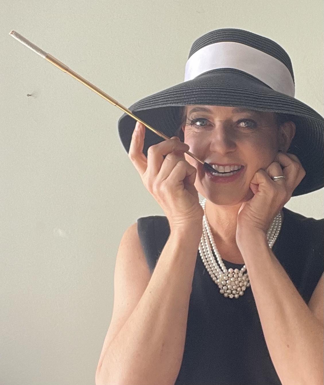 Goddard in Hepburn style clothes with her iconic long cigarette