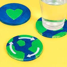 three coasters painted to look like the earth